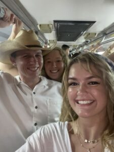 Paul left), Carly (middle), Maddie (right), ride the bus after a Texas A&M football game